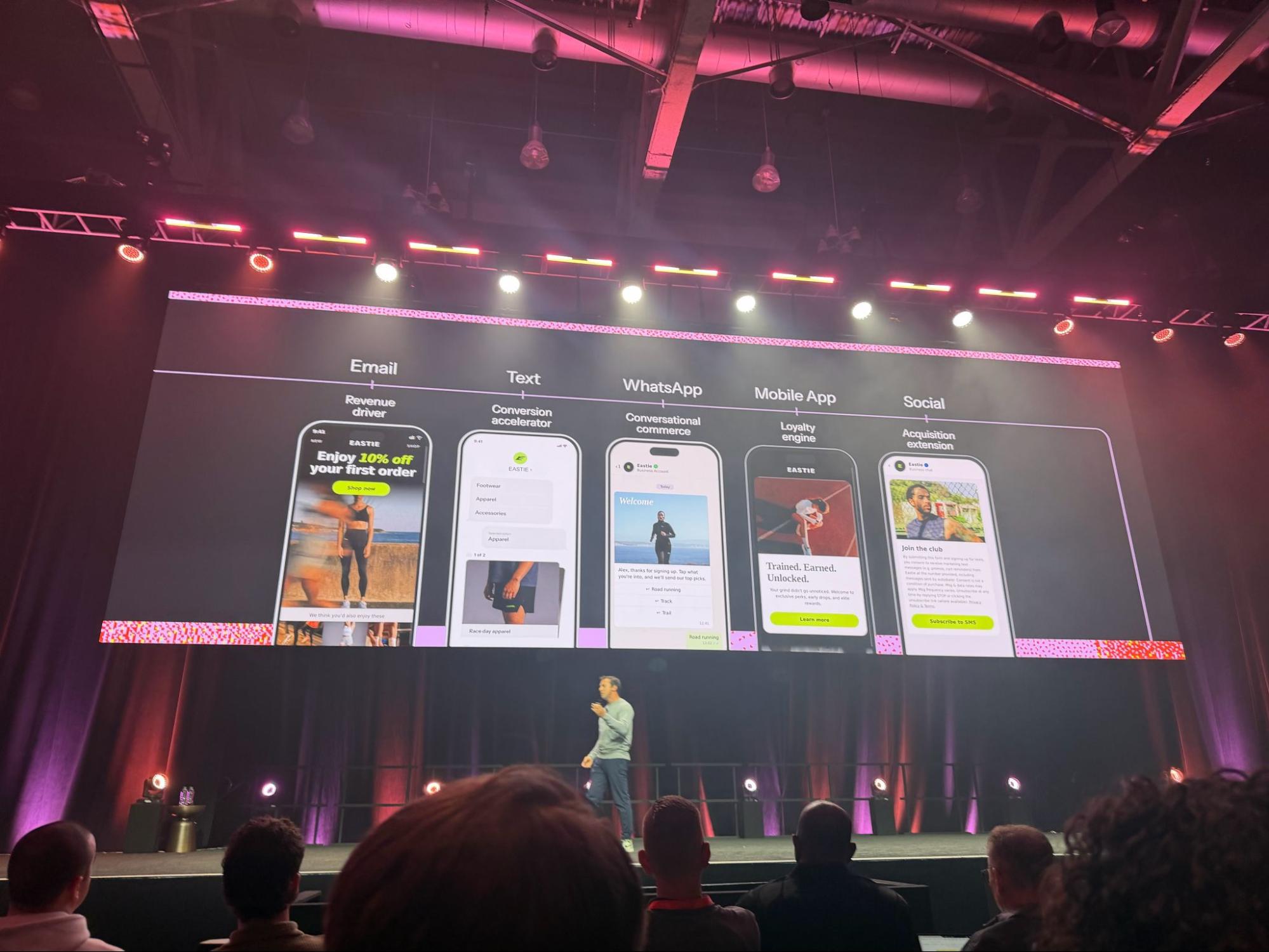 Speaker on stage presenting multichannel marketing examples at Klaviyo Boston 2026.