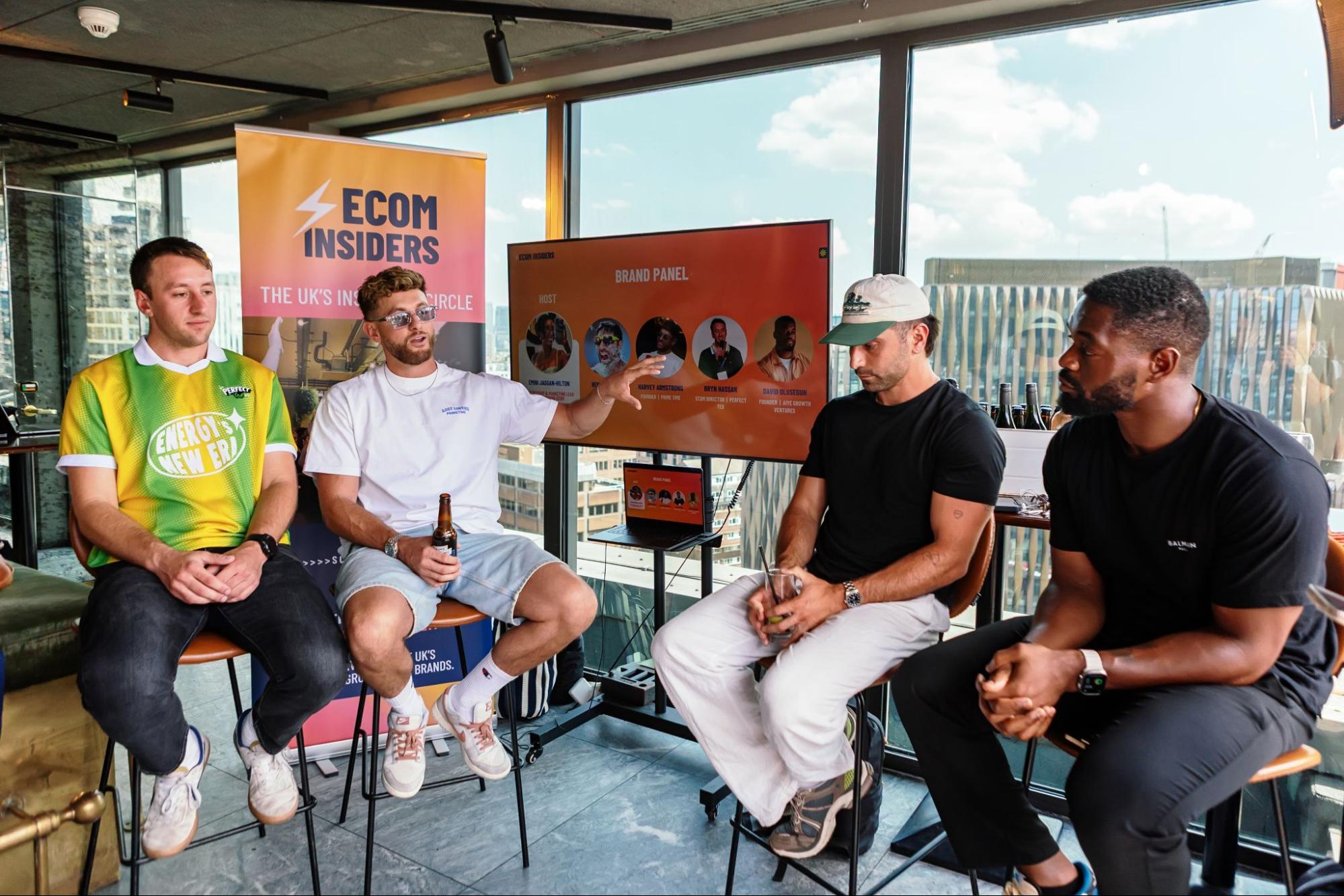 Panel discussion at an Ecom Insiders event in front of a brand banner.
